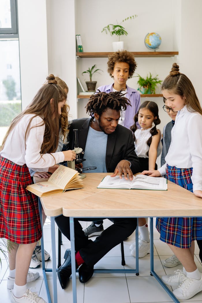 why-choose-us A teacher engages with students in a diverse classroom, fostering active learning.